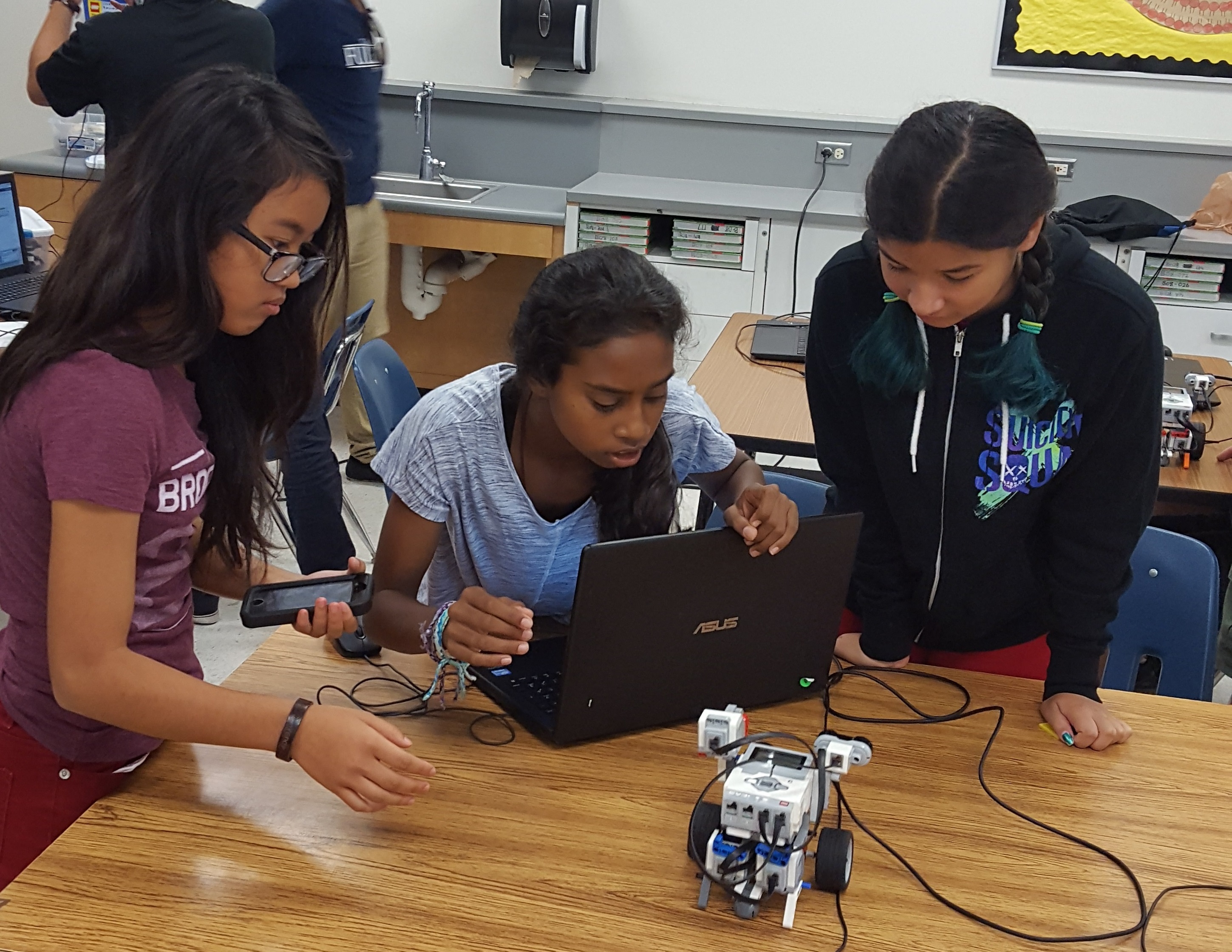 These young ladies work as a team to finish up their stem lab. Three minds are better than one!