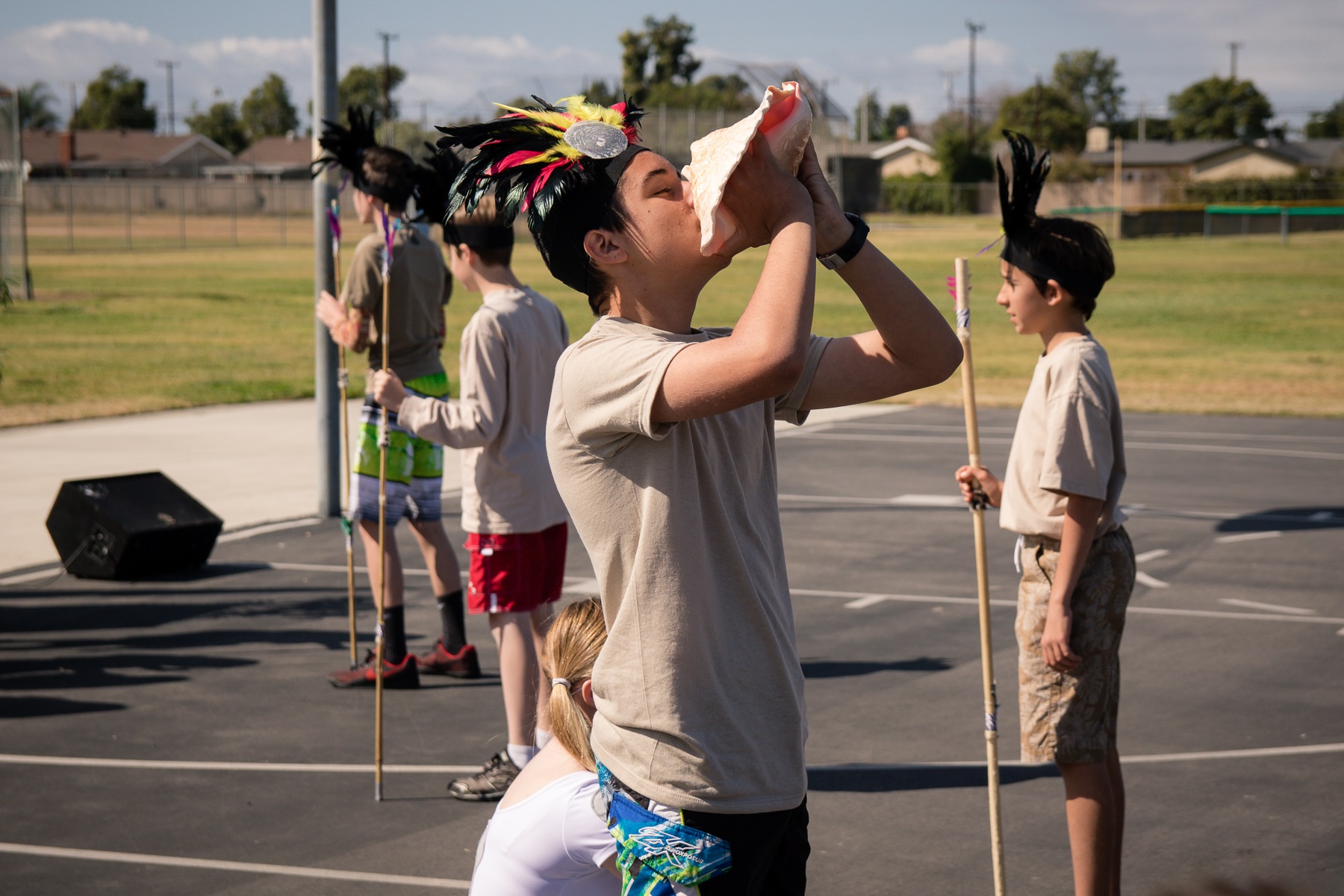 Our scholar blows on the magic conch throughout our Moana themed performance.